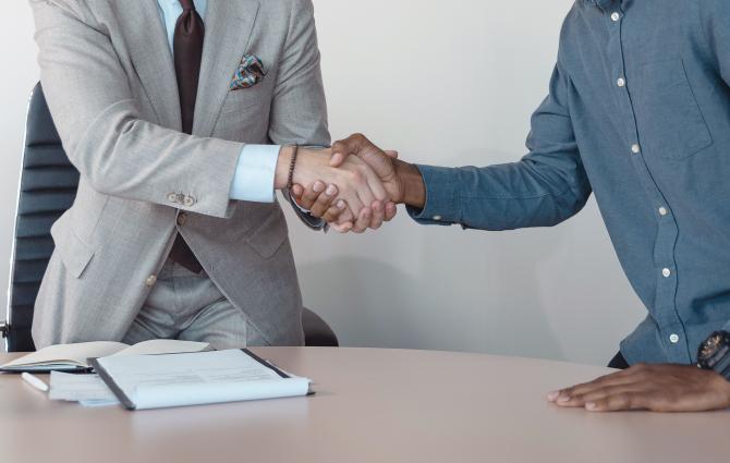 Two people engaging in a handshake